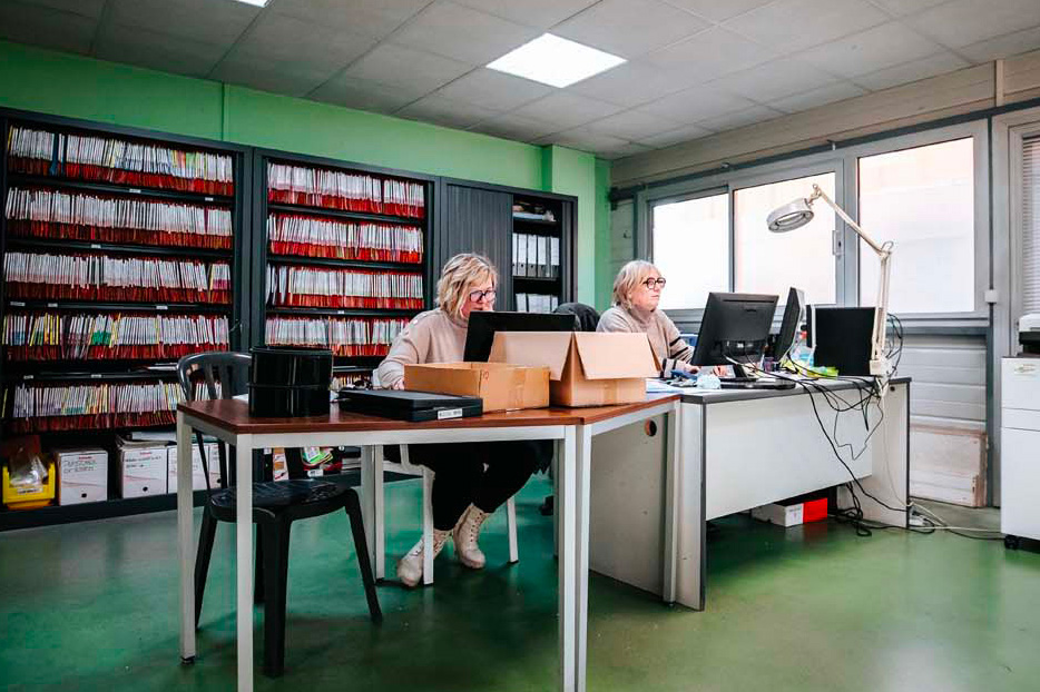 Employées de Credaplast au travail dans leur bureau avec ordinateurs et dossiers